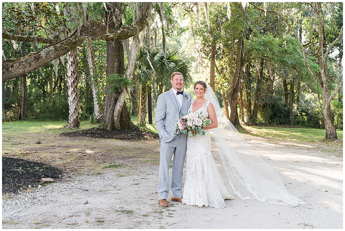 bride and groom pose on pathway in Charleston SC