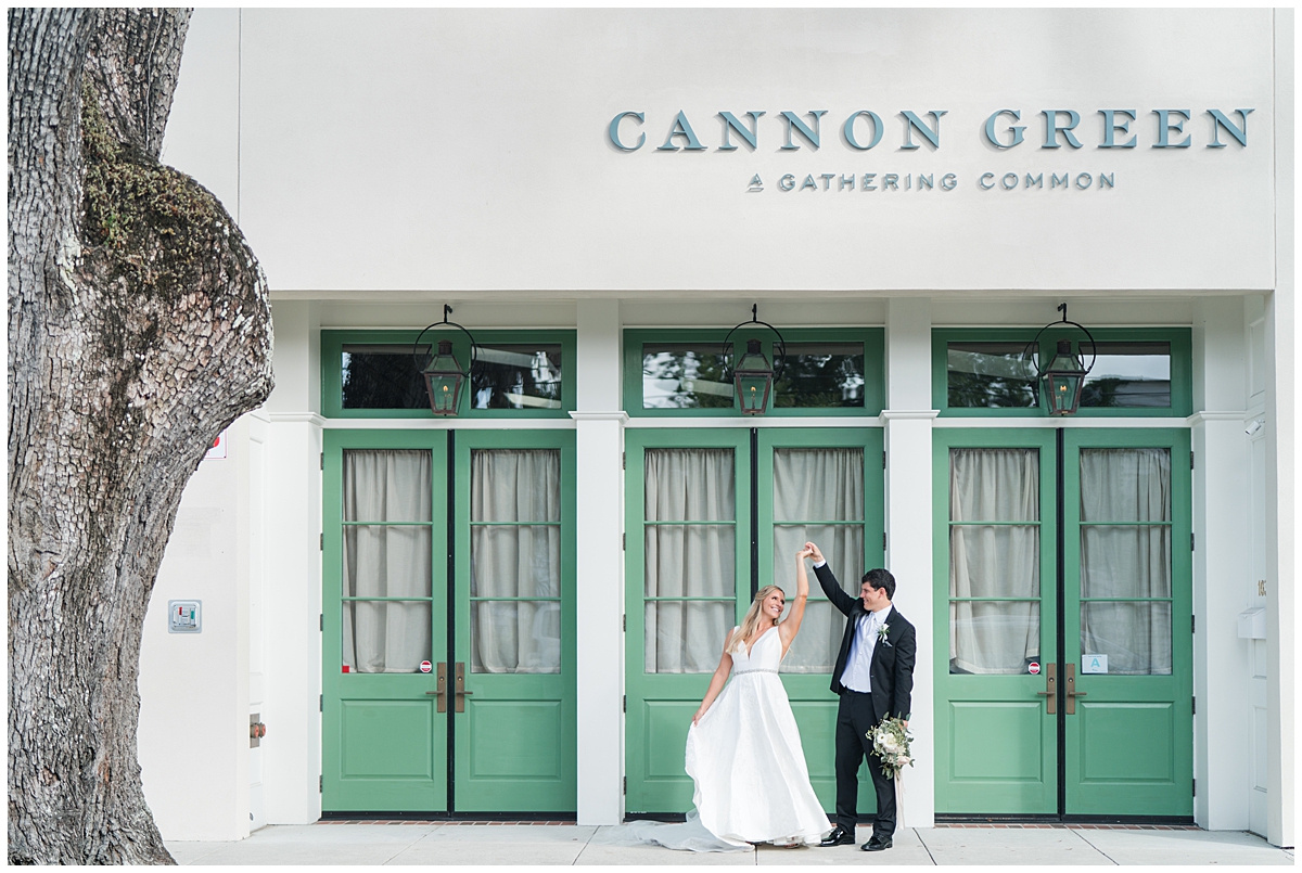 groom twirls bride outside Cannon Green